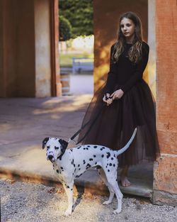 Portrait of young woman with dalmatian dog