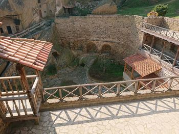 High angle view of empty bench against building