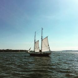 Sailboat sailing on sea against sky