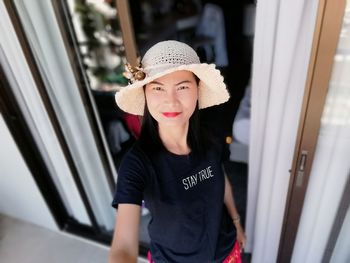 Portrait of smiling young woman wearing hat