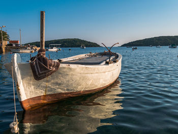 Boats moored on sea against sky