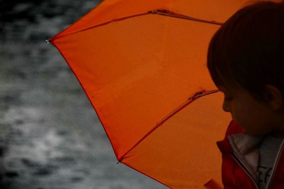 CLOSE-UP OF WOMAN IN ORANGE