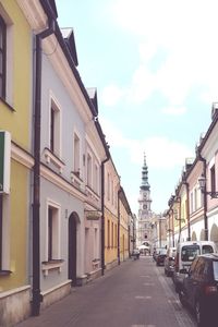 Street amidst buildings against sky in city