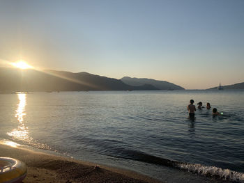 Scenic view of sea against clear sky during sunset