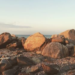 Rocks by sea against sky