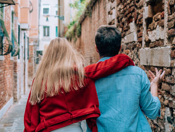 Rear view of couple kissing in city