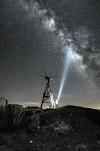 Low angle view of windmill against sky at night