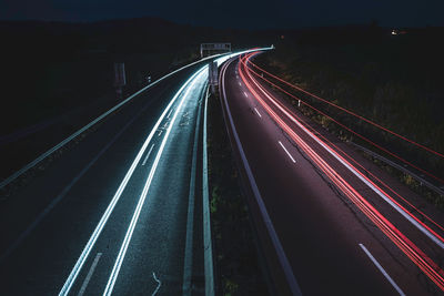 High angle view of light trails on highway at night