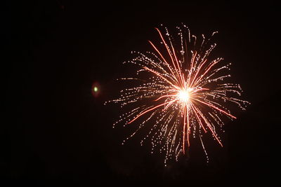 Low angle view of firework display at night