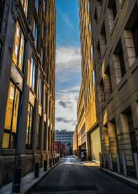 View of city street against cloudy sky