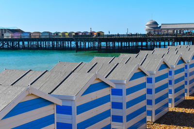 Buildings at beach against blue sky