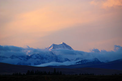 Scenic view of mountains against sky at sunset