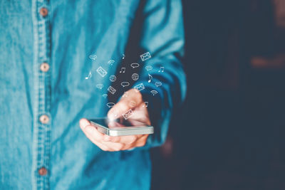 Midsection of woman using mobile phone