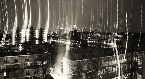 Illuminated cityscape against sky at night