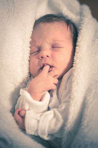 Cute baby sleeping with finger in mouth