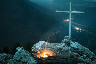 Close-up of fire on rock at night