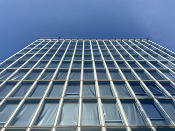 Low angle view of modern building against clear blue sky