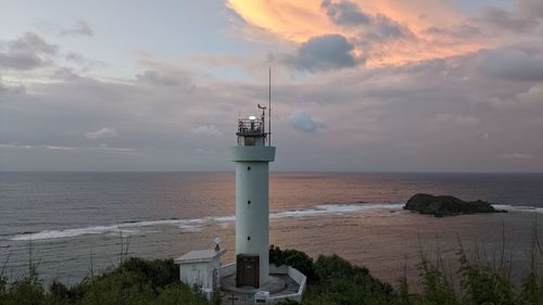 Lighthouse against the ocean in sunset