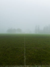 Scenic view of field against sky during foggy weather