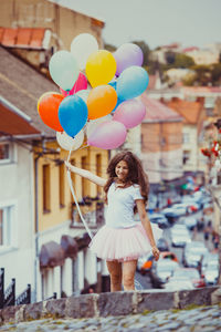 Full length of woman with colorful balloons