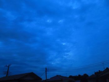 Low angle view of silhouette roof against sky