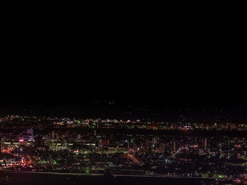 High angle view of illuminated buildings in city at night