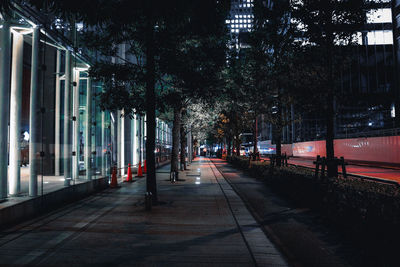 Street amidst buildings in city at night