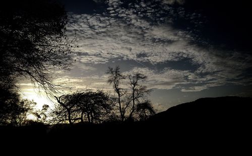 Silhouette landscape against sunset sky