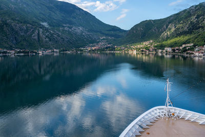 Scenic view of lake by mountains against sky