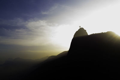 Low angle view of silhouette cross against sky during sunset