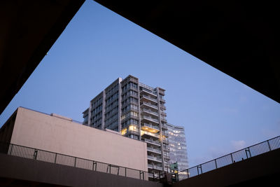 Low angle view of modern buildings against clear blue sky