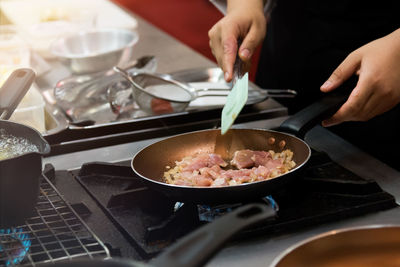 Midsection of man preparing food in kitchen