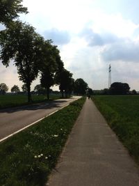 Empty road passing through field