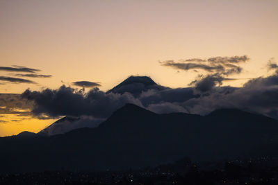 Scenic view of silhouette mountains against sky during sunset