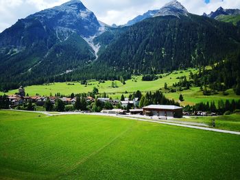 Scenic view of field and mountains against sky