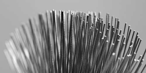 Close-up of metallic wire against gray background