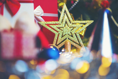 Close-up of christmas presents and star shape decoration