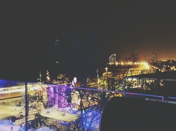 Illuminated bridge over river at night