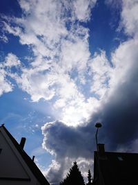 Low angle view of building against cloudy sky