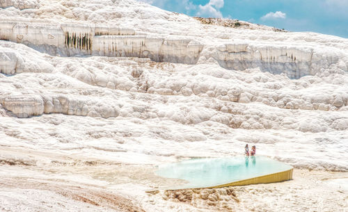 High angle view of people by travertine pool