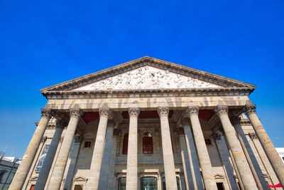 Low angle view of building against blue sky