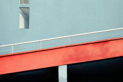 Low angle view of red driveway ramp against building