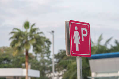 Close-up of road sign against trees