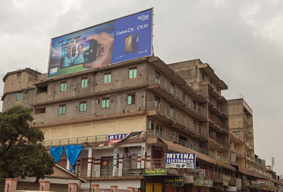 Low angle view of road sign against sky