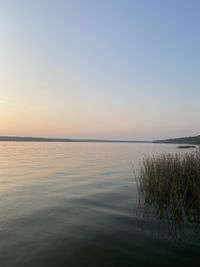 Scenic view of sea against clear sky during sunset