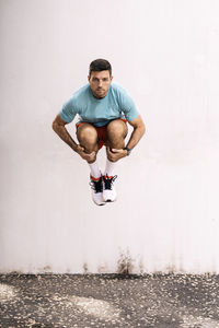 Isolated male athlete jumping outdoors