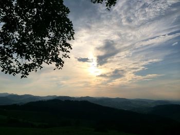 Scenic view of mountains against cloudy sky