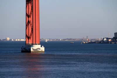 Ship sailing in sea against clear sky