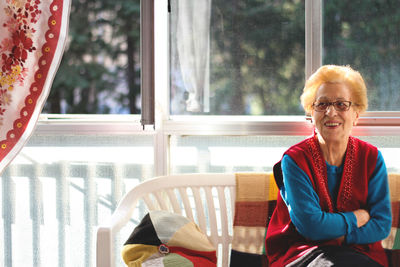 Smiling senior woman sitting at home