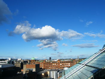 High angle view of buildings against blue sky